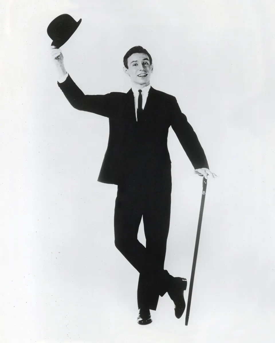 Young Dean Barlow in a derby, leaning on a cane